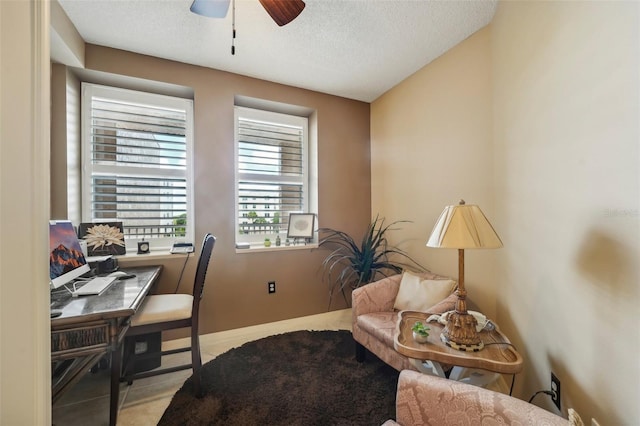 home office featuring a textured ceiling and ceiling fan