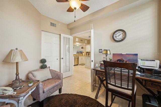 office space with ceiling fan, french doors, light tile patterned floors, and a textured ceiling