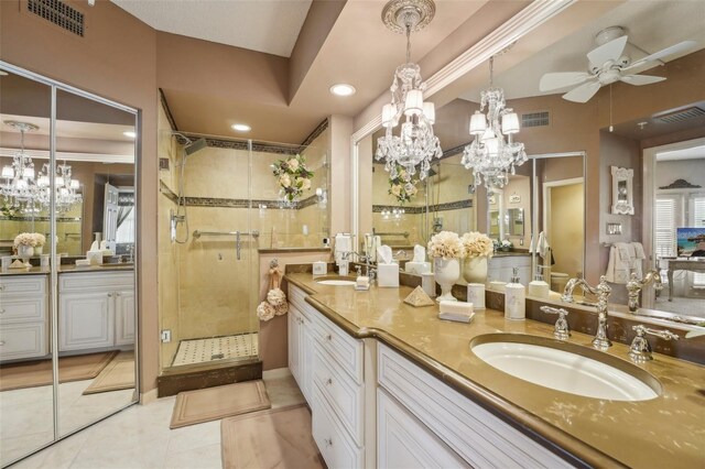 bathroom with tile patterned floors, ceiling fan, vanity, and walk in shower