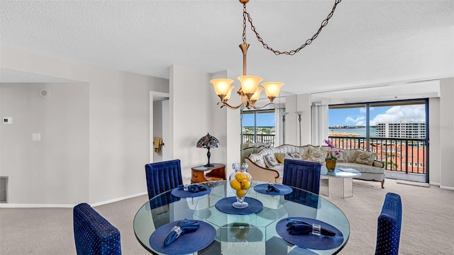 carpeted dining space featuring a textured ceiling and an inviting chandelier