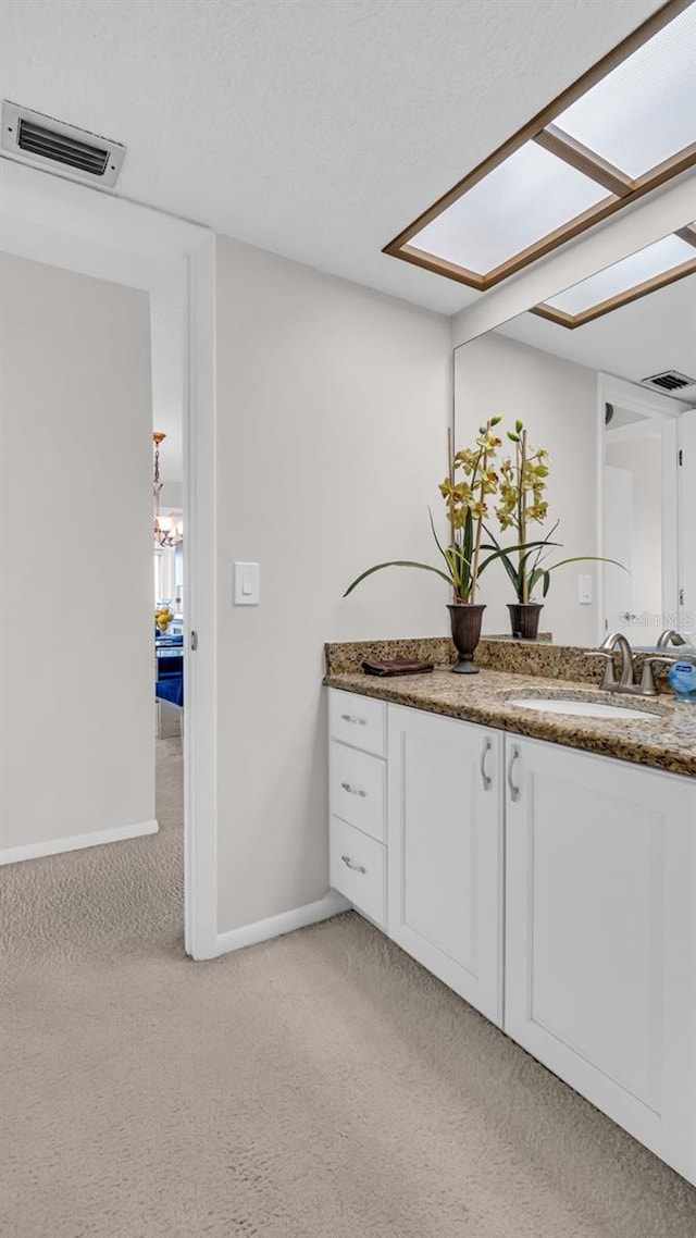 bathroom with vanity and a skylight