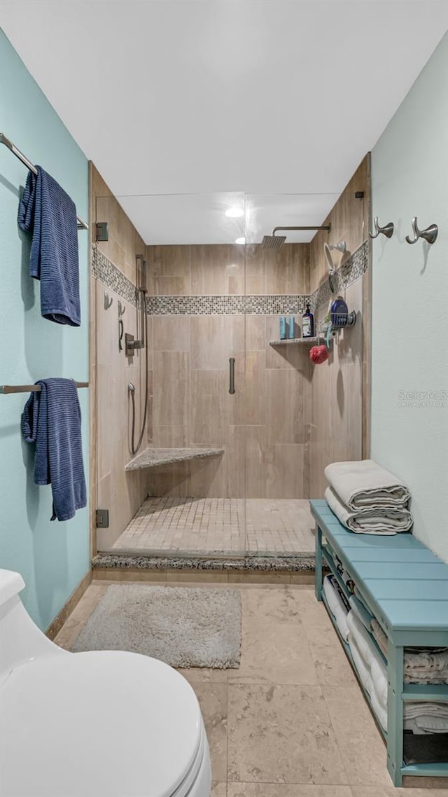 bathroom with toilet and walk in shower