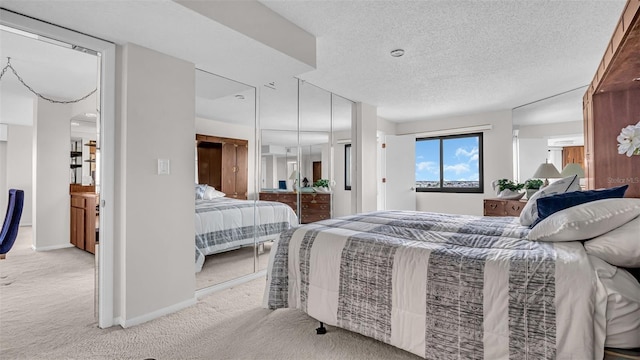 bedroom with a textured ceiling and light colored carpet