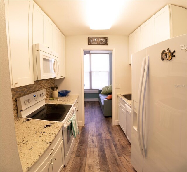 kitchen featuring dark hardwood / wood-style flooring, white cabinetry, and white appliances