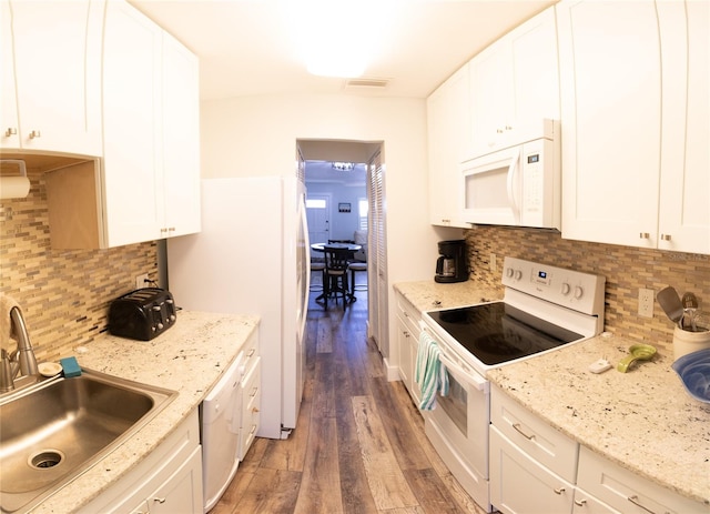 kitchen featuring sink, decorative backsplash, dark wood-type flooring, and white appliances