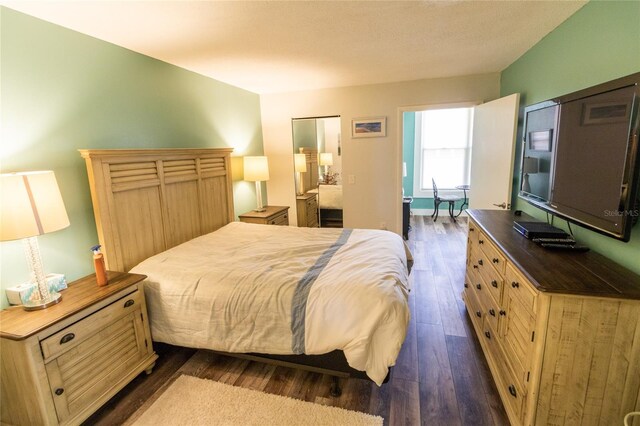 bedroom featuring dark hardwood / wood-style flooring and a closet