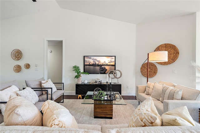 living room featuring vaulted ceiling and hardwood / wood-style flooring