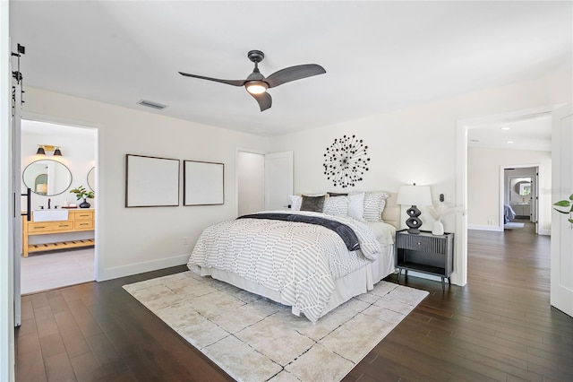 bedroom with sink, wood-type flooring, and ceiling fan