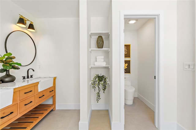 bathroom with vanity, toilet, and tile patterned flooring