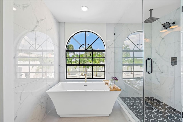 bathroom with plus walk in shower and tile walls