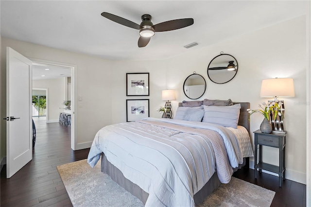 bedroom with ceiling fan and dark hardwood / wood-style flooring