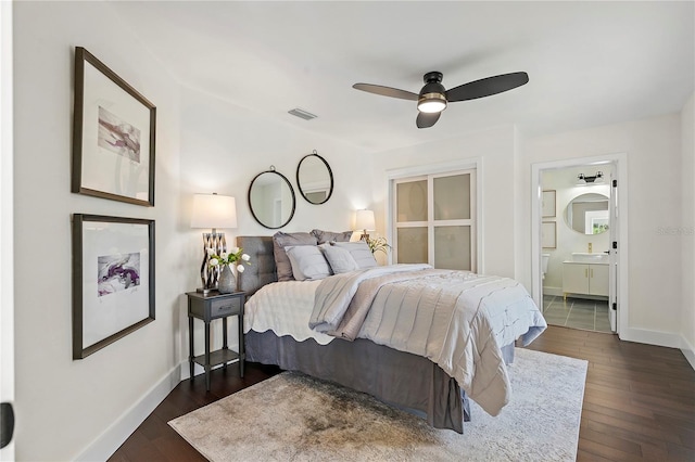 bedroom with connected bathroom, dark wood-type flooring, and ceiling fan