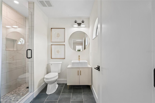 bathroom with toilet, tile patterned flooring, vanity, and a shower with door