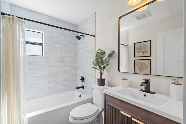 full bathroom with vanity, shower / tub combo, and toilet