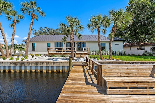 view of dock with a deck with water view