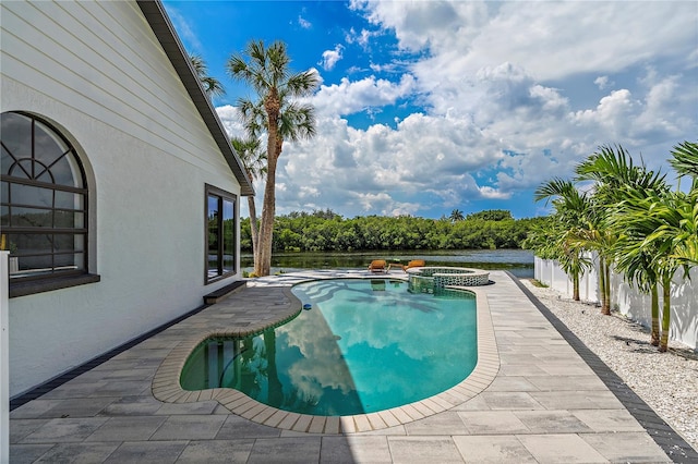 view of swimming pool with a patio, an in ground hot tub, and a water view