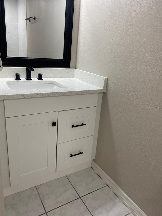 bathroom with tile patterned flooring and vanity