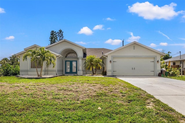 single story home with a front yard, french doors, and a garage