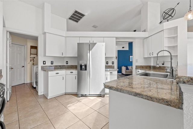 kitchen with sink, light tile patterned floors, pendant lighting, stainless steel fridge with ice dispenser, and white cabinetry