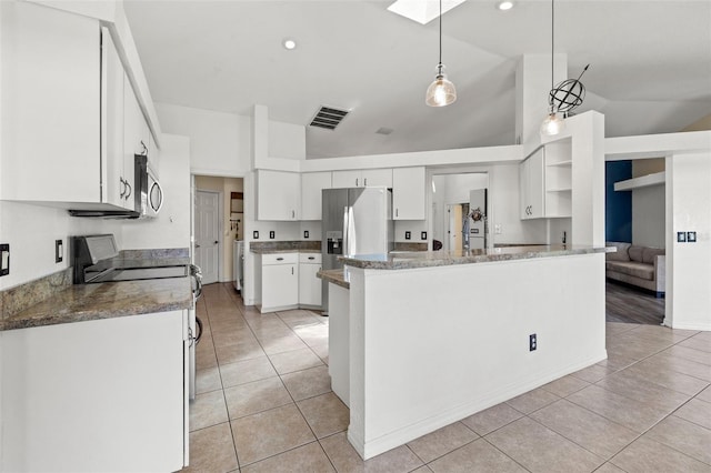 kitchen with kitchen peninsula, stainless steel appliances, pendant lighting, white cabinets, and lofted ceiling