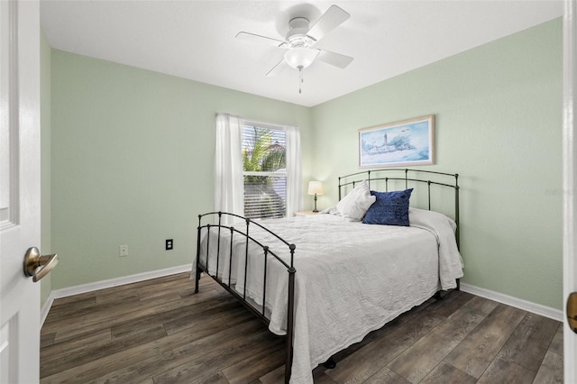 bedroom with ceiling fan and dark hardwood / wood-style floors