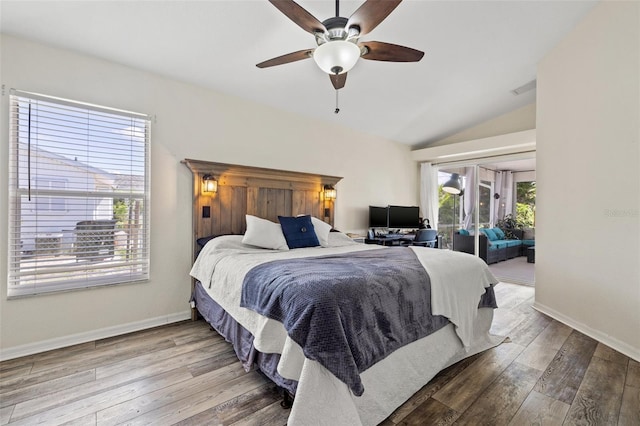 bedroom featuring multiple windows, ceiling fan, wood-type flooring, and lofted ceiling