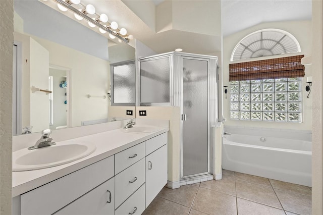 bathroom with tile patterned flooring, vanity, vaulted ceiling, and plus walk in shower