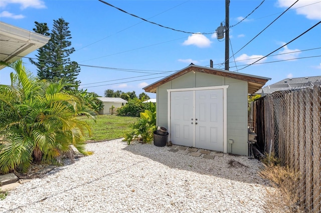 view of outbuilding with a lawn