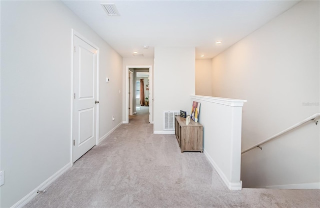 hallway with light colored carpet