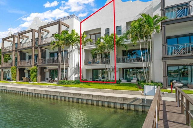 exterior space featuring a balcony and a water view