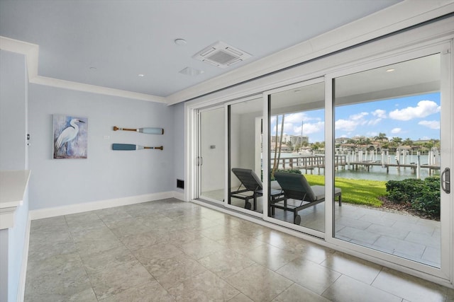 empty room featuring light tile patterned flooring, a water view, and crown molding