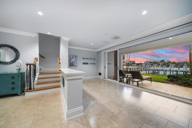 interior space with light tile patterned floors and ornamental molding