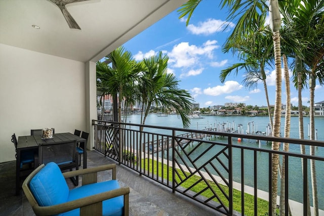 balcony with a water view and ceiling fan