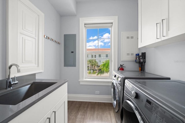 laundry area with separate washer and dryer, a healthy amount of sunlight, electric panel, and dark hardwood / wood-style floors