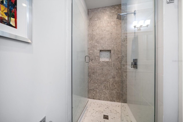 bathroom featuring a shower with door