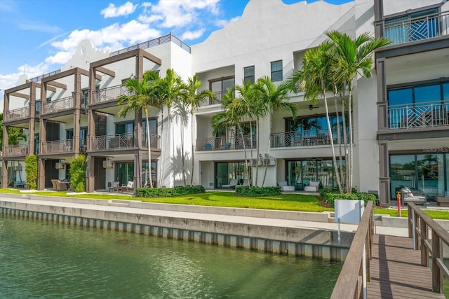 exterior space featuring a balcony and a water view