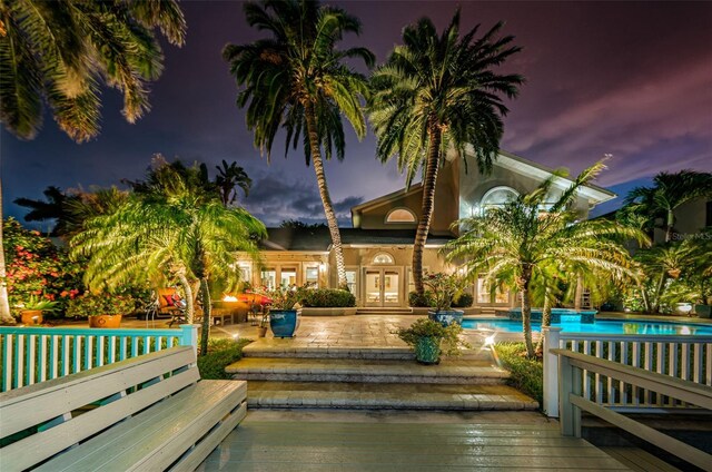 view of pool featuring a deck and french doors