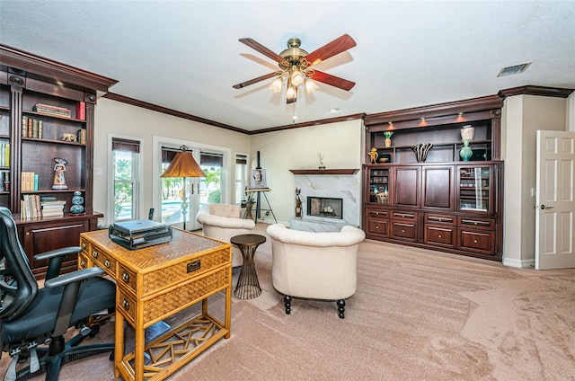 carpeted office featuring ornamental molding, a textured ceiling, ceiling fan, and a high end fireplace