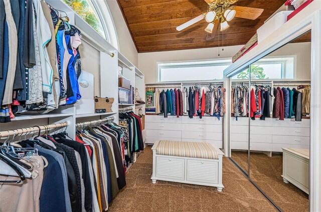 spacious closet with carpet floors, ceiling fan, and vaulted ceiling