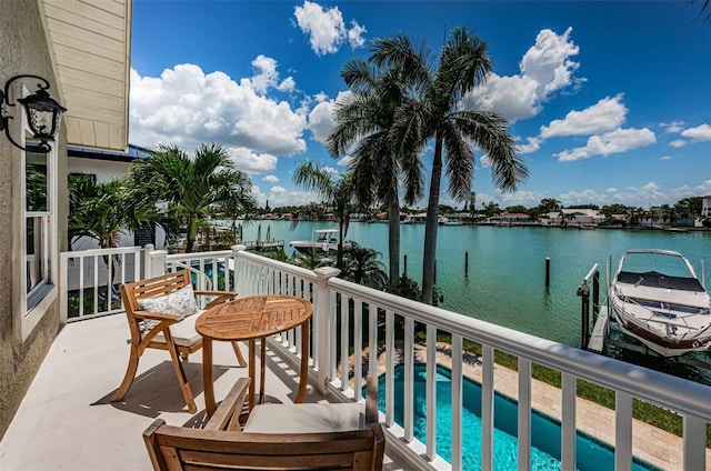 balcony featuring a water view and a dock