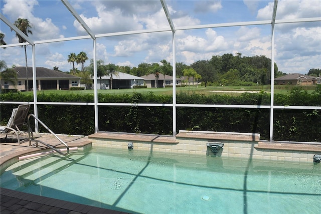 view of swimming pool with glass enclosure