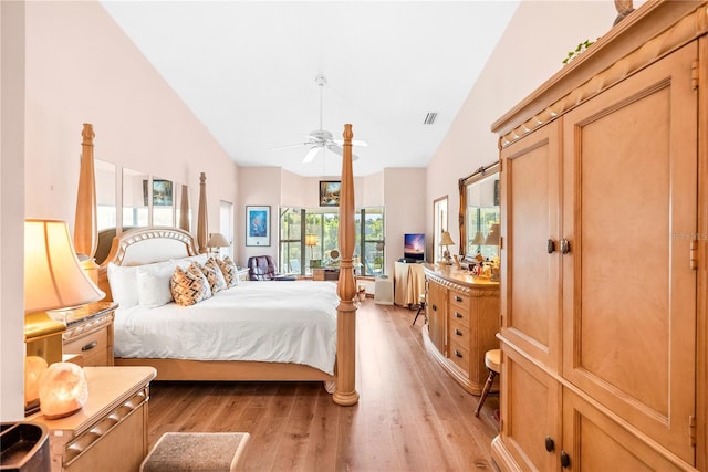 bedroom featuring high vaulted ceiling, ceiling fan, and light wood-type flooring