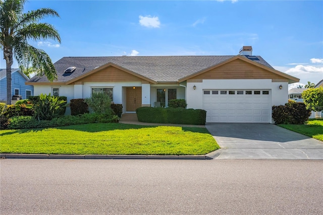 single story home featuring a garage and a front yard