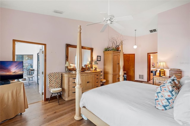 bedroom featuring lofted ceiling, ceiling fan, and light hardwood / wood-style flooring