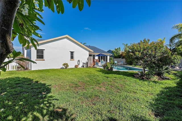 back of house featuring a yard