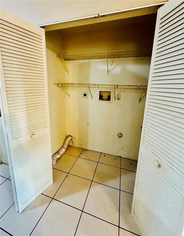 laundry room featuring hookup for an electric dryer, washer hookup, and light tile patterned flooring