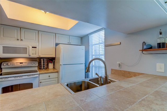 kitchen with white cabinetry, sink, and white appliances