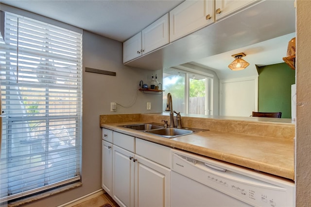 kitchen with white cabinetry, sink, and white dishwasher