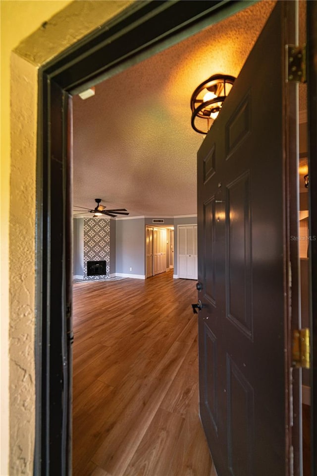 hallway featuring a textured ceiling and hardwood / wood-style flooring