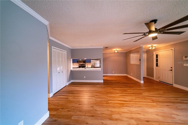 unfurnished living room featuring a textured ceiling, light hardwood / wood-style flooring, ceiling fan, and ornamental molding